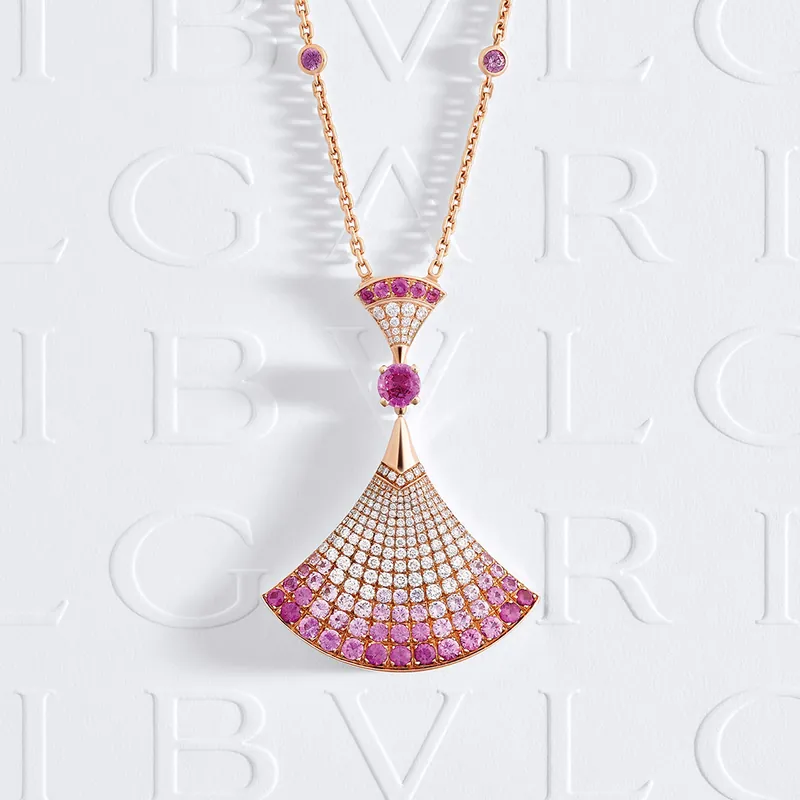 Divas' Dream pendant on a rose-gold chain, the fan paved with diamonds shading to pink sapphires below a round pink sapphire, on embossed BVLGARI paper