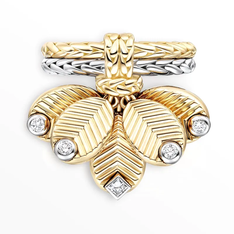 Grain de Café ring in yellow and white gold: four grooved gold coffee beans tipped with diamonds, on a pale grey ground.