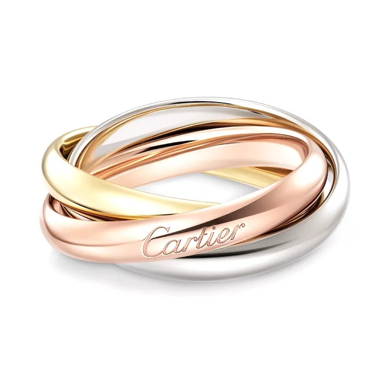 Trinity ring, classic model: three interlinked bands of yellow, rose and white gold, on a pale grey ground.