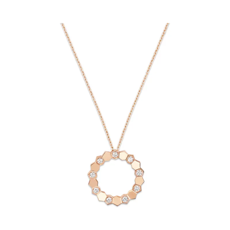 Bee de Chaumet medium pendant in rose gold: an open circle of hexagonal honeycomb cells, some set with diamonds, on a fine chain, on a transparent ground.