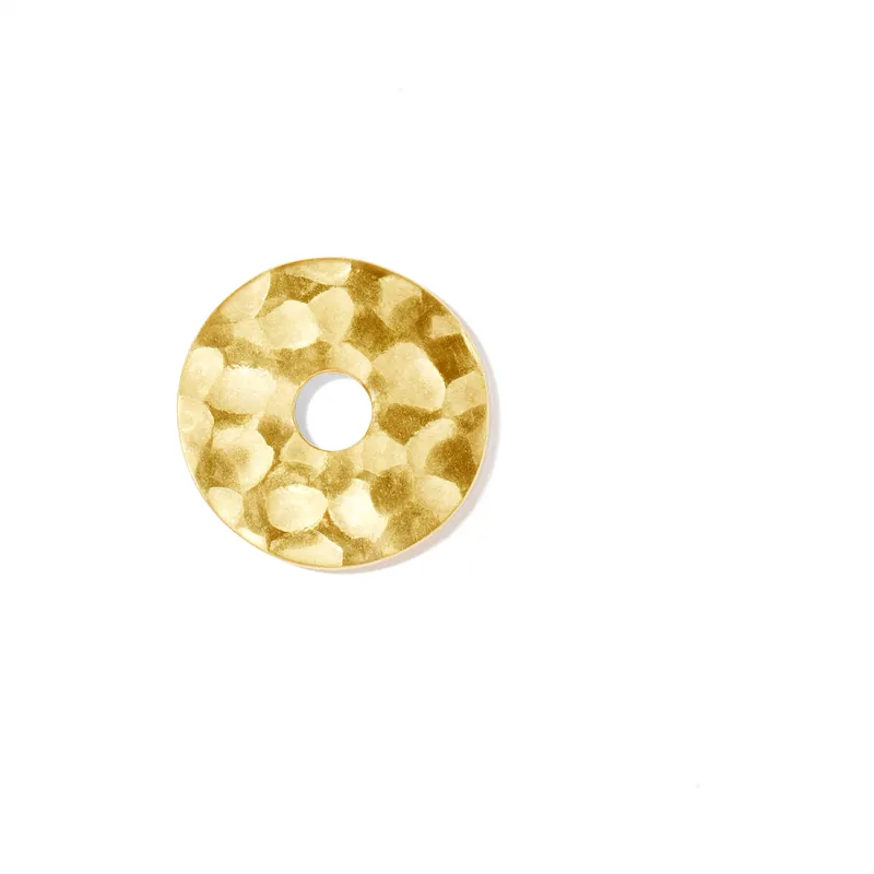 Pi pendant: a hand-hammered disc of 24-carat yellow gold with a central hole, on a white ground.