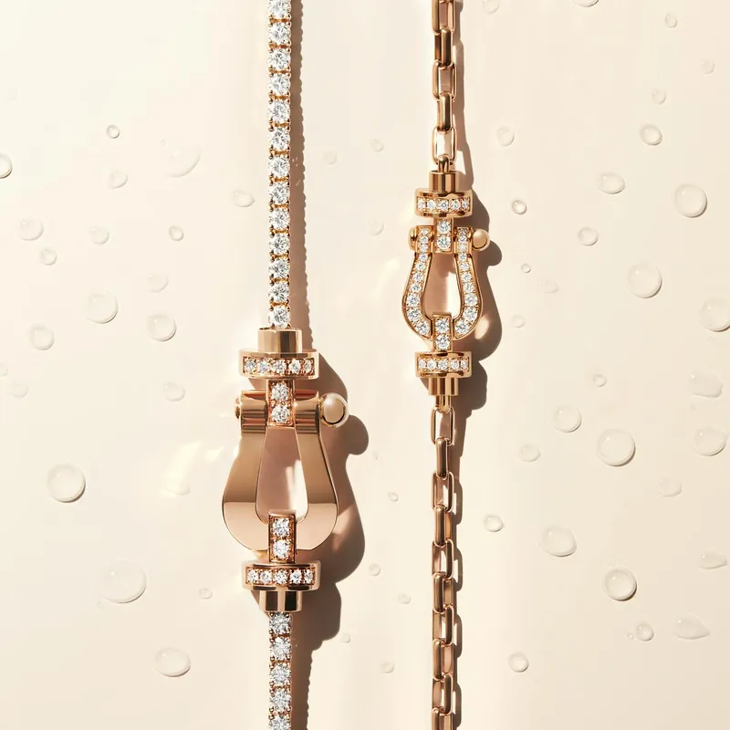 Two Force 10 bracelets in rose gold with diamond-set shackles, one on a diamond line, one on a gold chain, on a cream ground with water drops