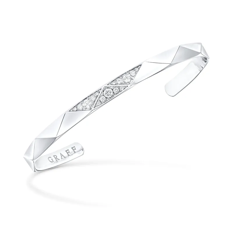 Laurence Graff Signature open bangle in white gold with angular faceted surfaces and a band of pavé diamonds at the centre
