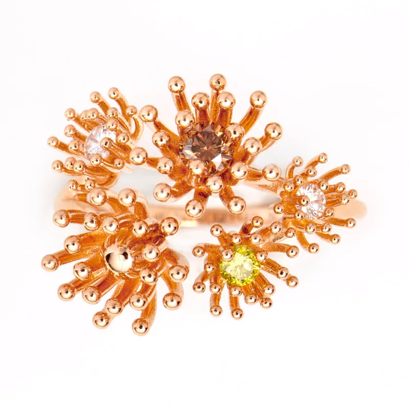 Le Petit Cactus ring with five rose gold cactus flowers of spiky stamens, each centred on a white, brown or yellow diamond, on a cream ground