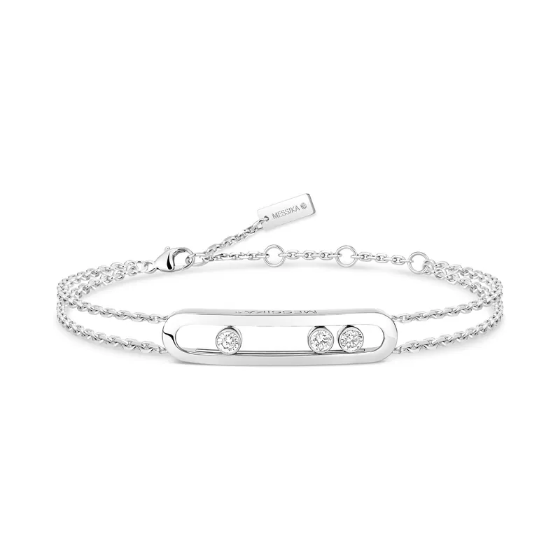 Move Classique double-chain bracelet in white gold: an open gold cage holding three diamonds that slide along it, on a pale grey ground.