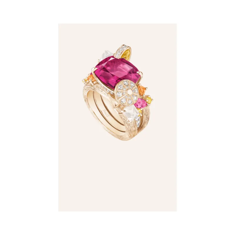 Piaget Solstice high jewellery ring in gold: stacked bands carrying a large cushion-cut pink centre stone with smaller coloured gems and diamonds, on a pale portrait panel within a transparent square.