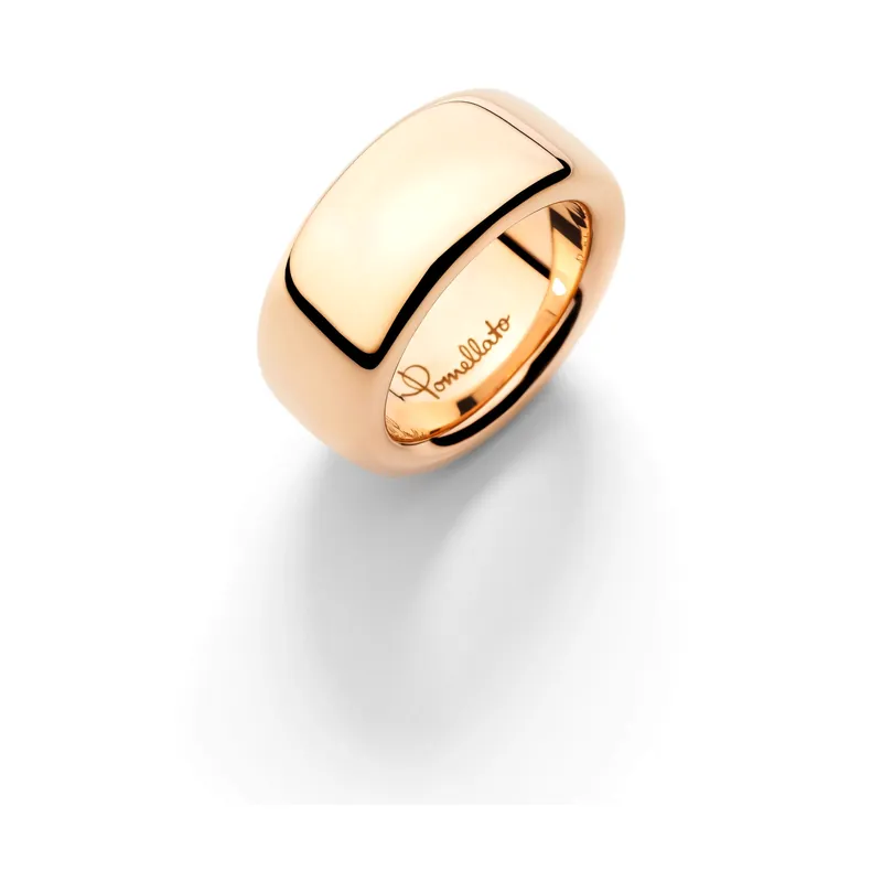 Iconica Large ring: a wide, smooth rose-gold band with rounded edges and the Pomellato signature engraved inside, on a pale grey ground.