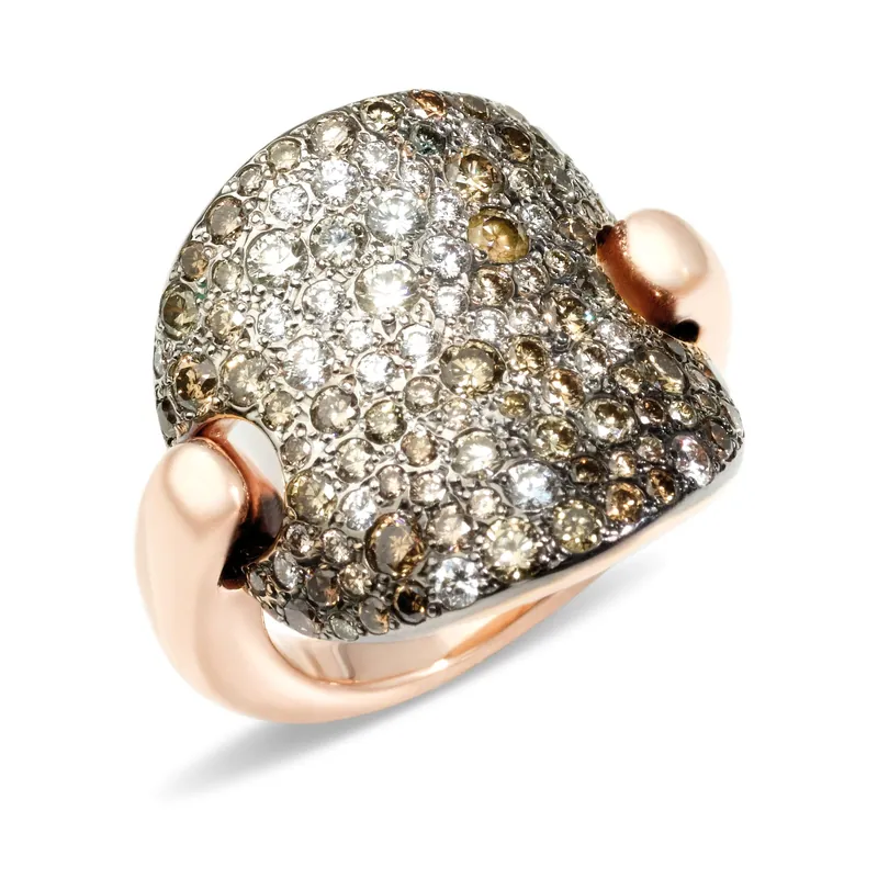 Sabbia ring: a rounded dome covered in white and brown diamonds of different sizes, on a rose-gold band, on a pale grey ground.