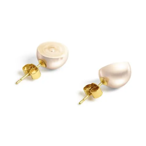 SLICED earrings: two halved pearls on yellow gold posts, one showing its cut, banded interior